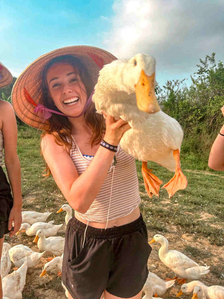 Shannon holding a duck at the Duck Stop in Vietnam