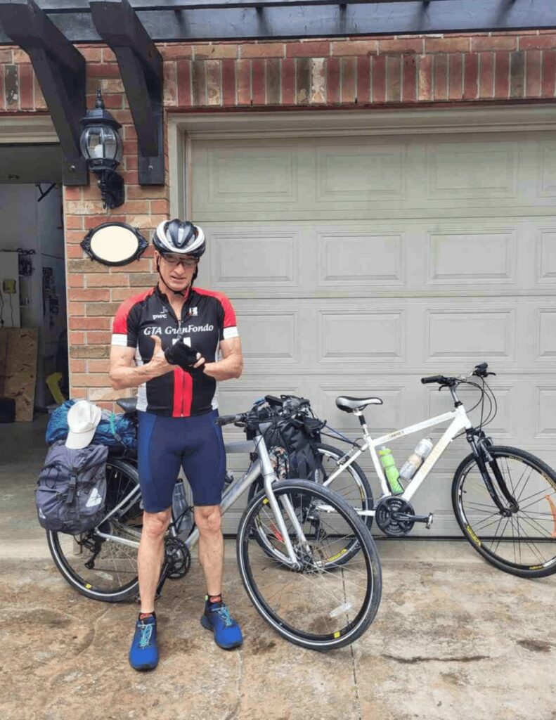 My dad posing in front of our packed bikes