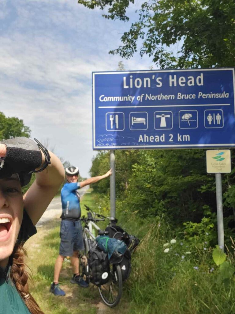 A sign of my dad and I touching the Lions Head town sign when we arrived